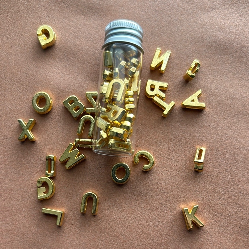 Gold Letter Charms in Clear Bottle. A-Z